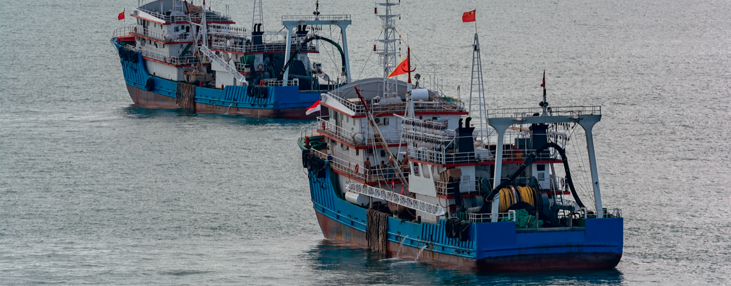 Chinese commercial fishing boats moored on the outer anchorage in Strait of Singapore.