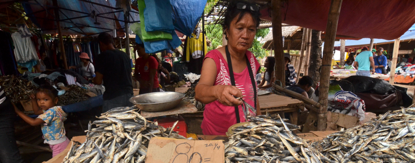 PHILIPPINES, NEGROS ISLAND - MARCH 27, 2019: people sells traditional dried fish on the market in the city of Malatapay