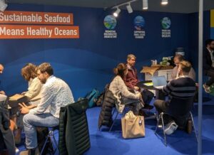 SFP Booth at Seafood Expo Global 2024, with multiple meetings around tables taking place