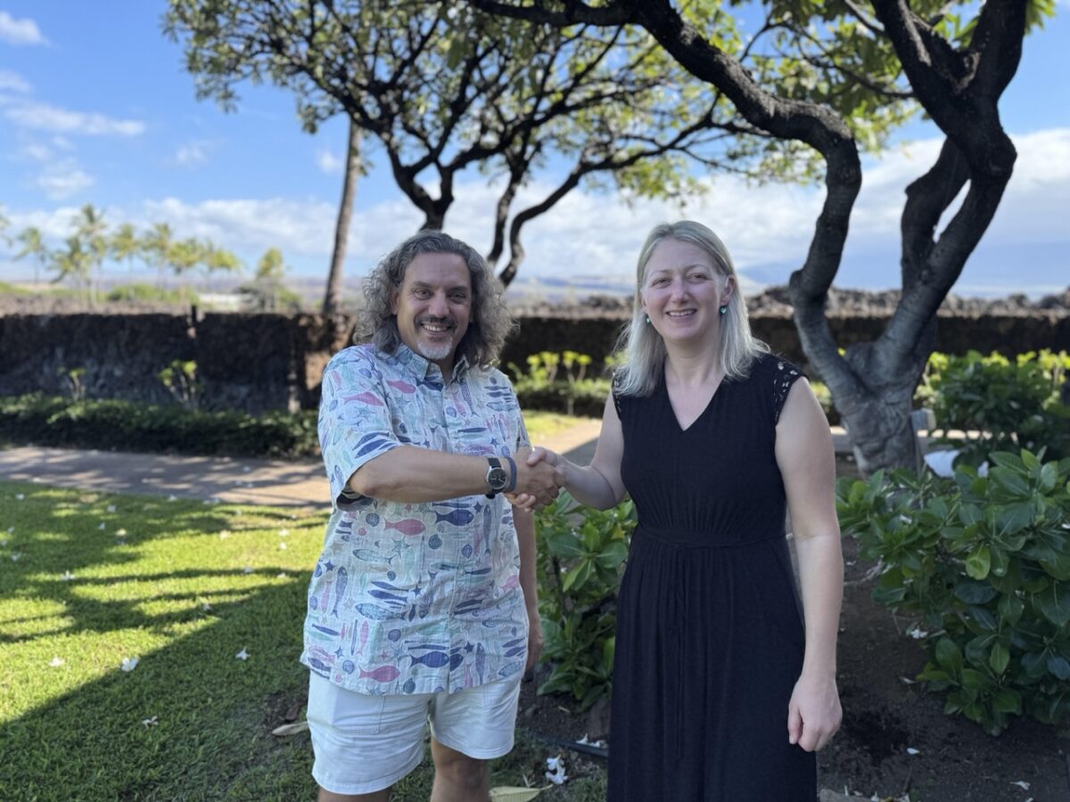 Jim Cannon, CEO of SFP and Kelly Harrell, Executive Director at Ocean Outcomes, shake hands in Hawaii