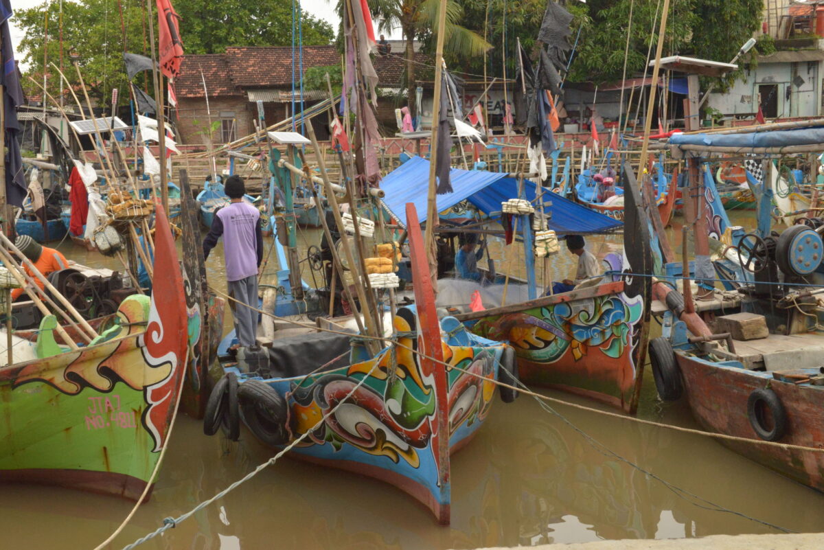 A row of colorful fishing boats in Jepara Indonesia