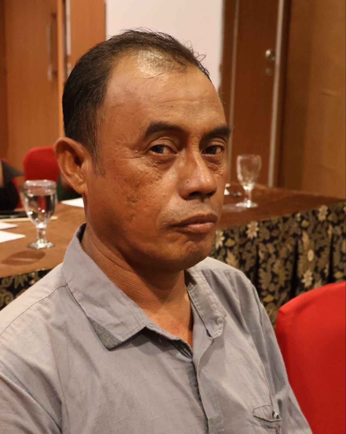 A photograph of Erwin RH, the chair of the Indonesia National Demersal Fishers Network