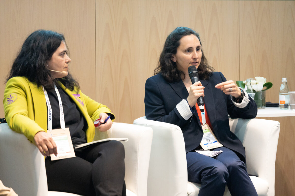 Two women speaking at an event