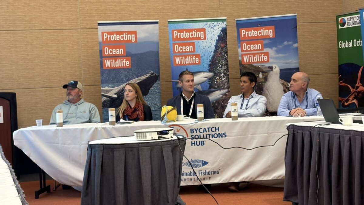 Innovative gear panelists behind a long table