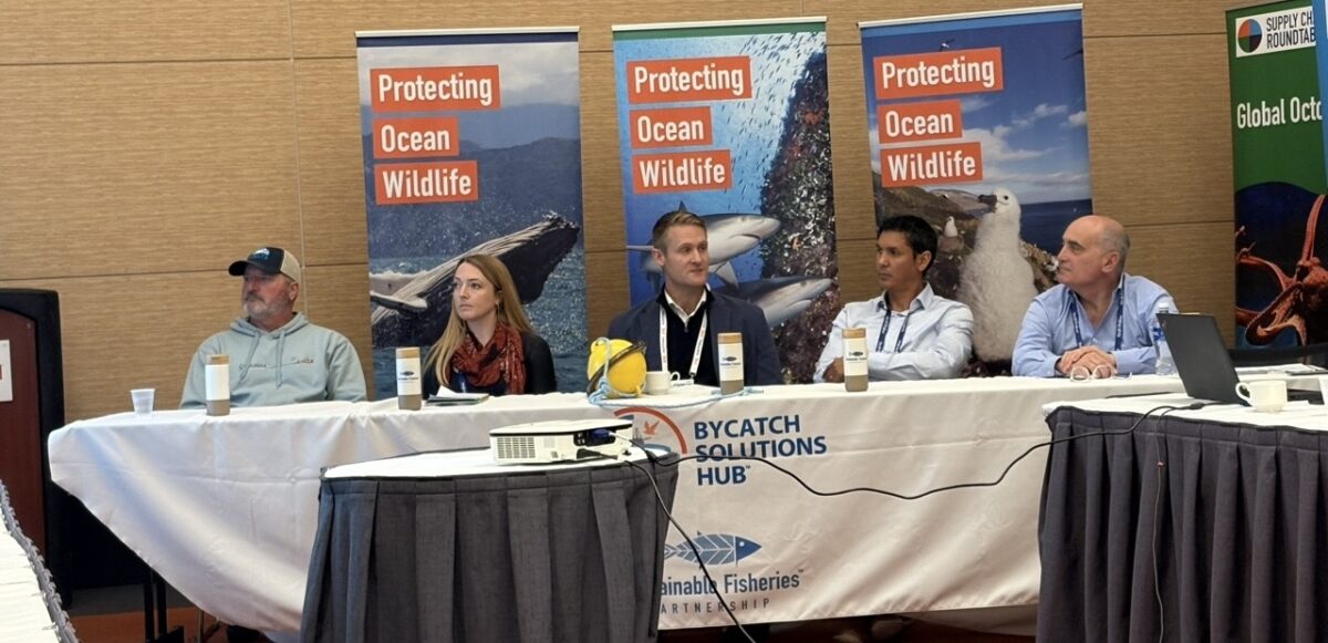 Innovative gear panelists behind a long table