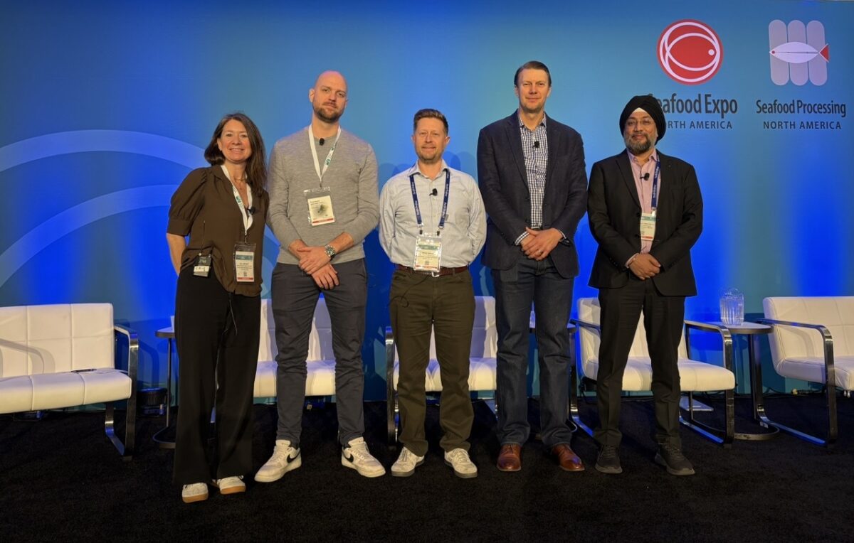 Panelists standing in a row on stage