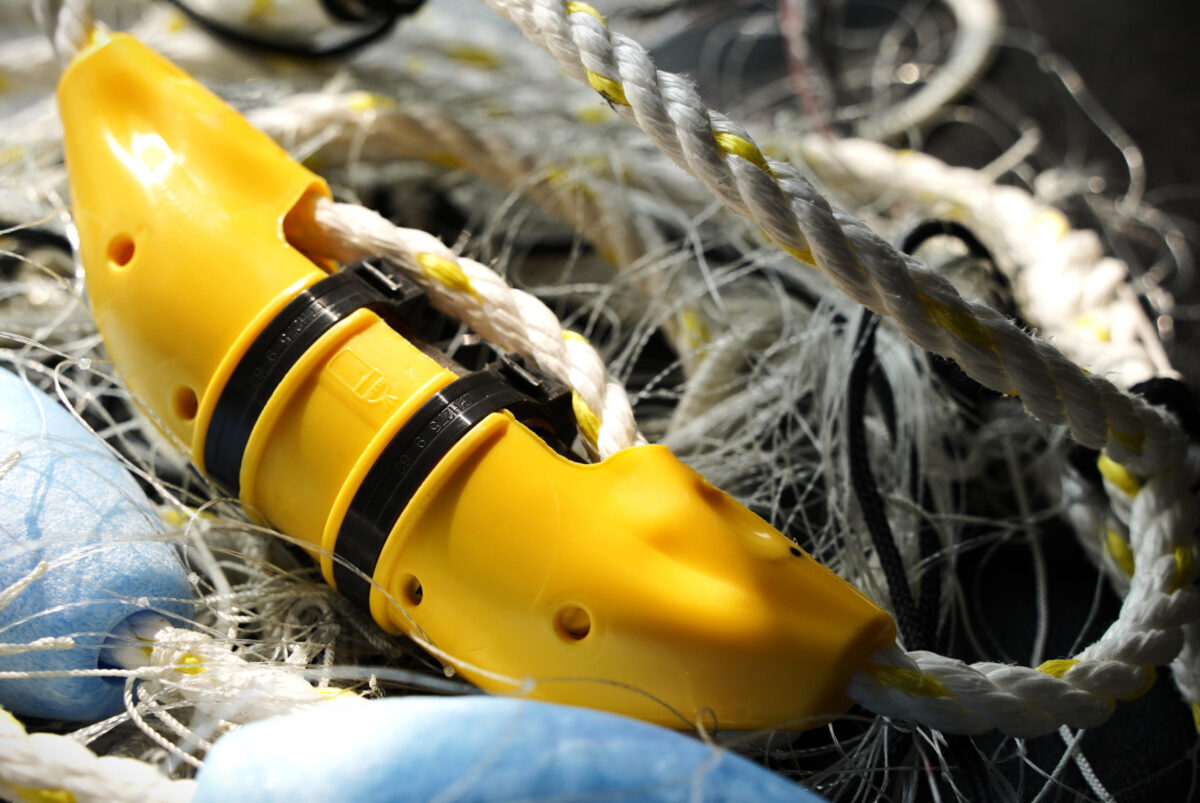 A yellow acoustic pinger to be used on fishing nets to repel dolphins