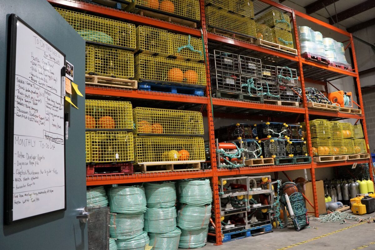CanFISH gear lending library in Halifax - yellow and orange on-demand crab traps stacked floor to ceiling on shelves