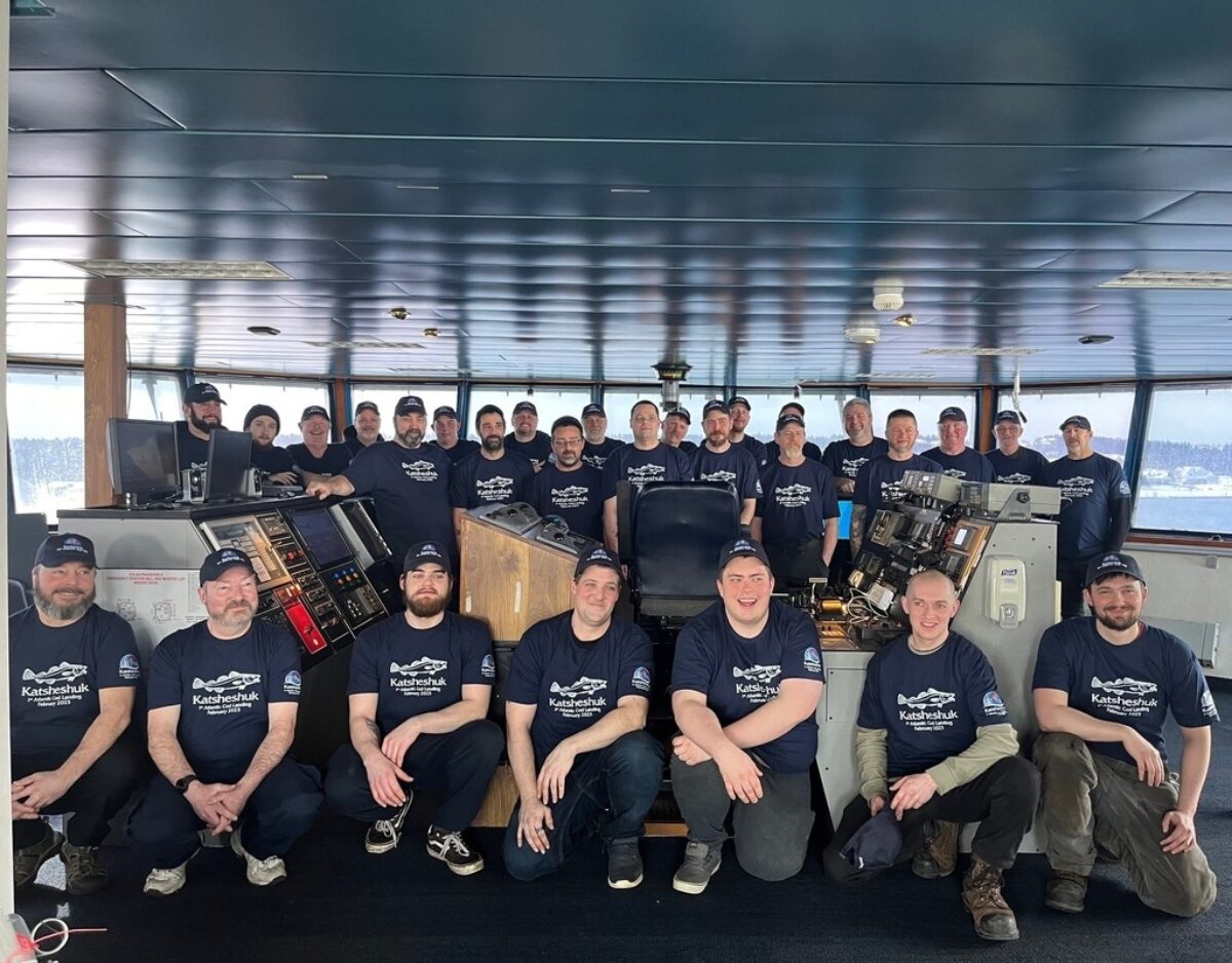 Crew of the Katsheshuk II cod fishing vessel posing on the bridge