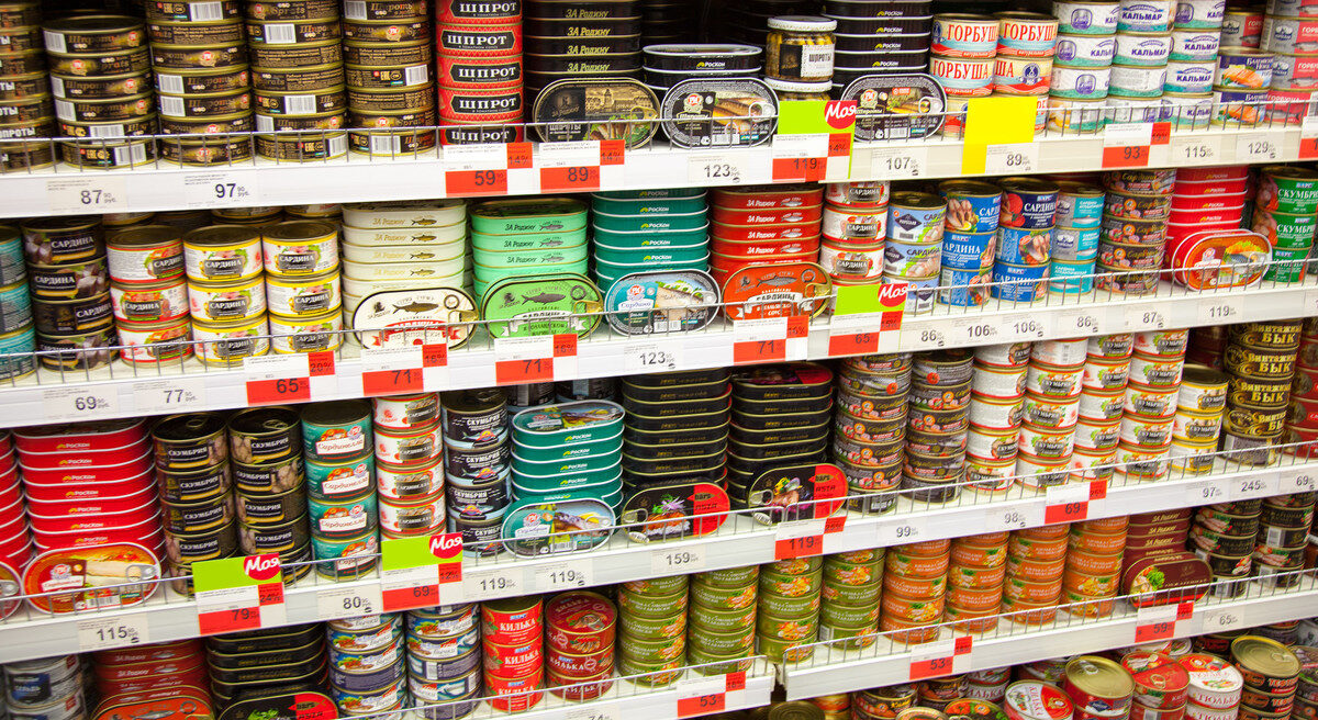 Tinned fish on display on a supermarket shelf